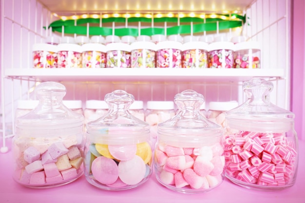 Different sweets in jars at candy shop