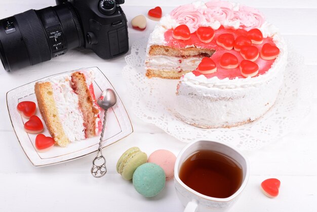 Different sweets and photo camera on table top view