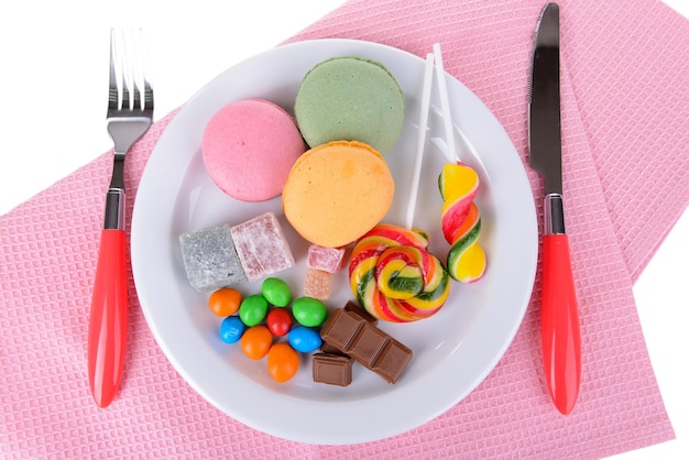 Different sweets on plate on table close-up