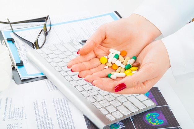 Different tablets, pills in woman's hands