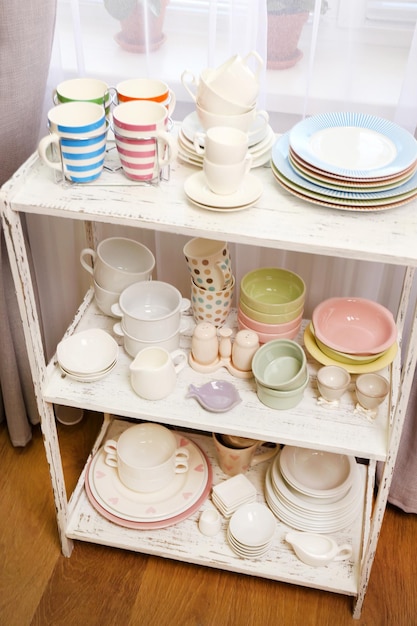 Different tableware on shelf in the interior