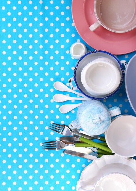 Photo different tableware on tablecloth, top view