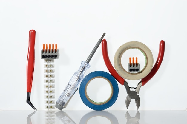 Different tools for electronics repair laid out on a white background