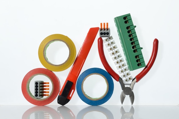 Different tools for electronics repair laid out on a white background