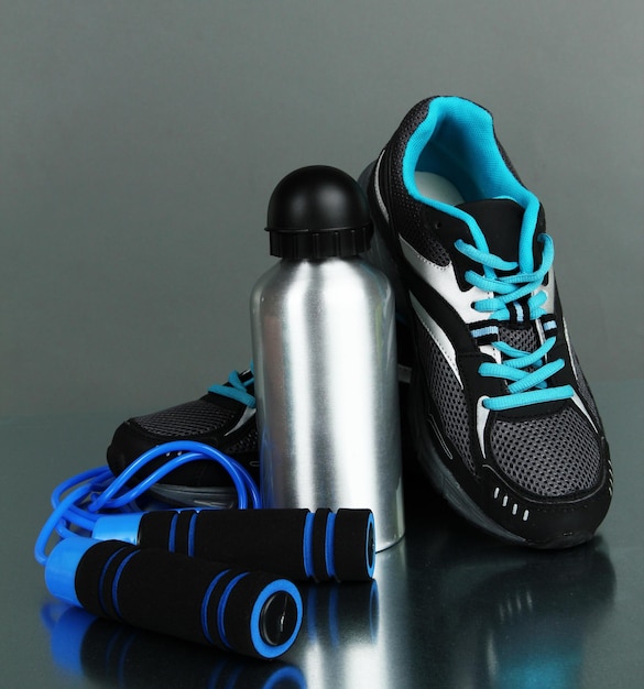 Photo different tools for sport on grey background