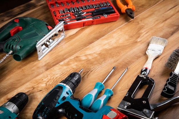 Different tools on the wooden table background