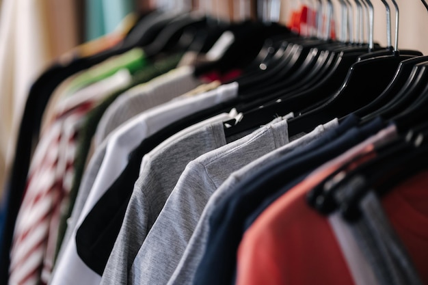 Different tshirts on a hanger in a clothing store close up of multicolored shirts