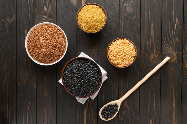 Different type of composition of raw dry legumes and cereals Black beans bulgur peas and buckwheat