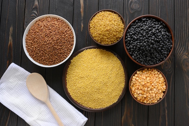 Different type of composition of raw dry legumes and cereals Black beans bulgur peas and buckwheat
