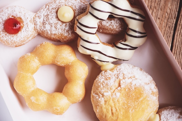 Different type of donuts set, sweet donuts in a paper donut box dessert snack food.