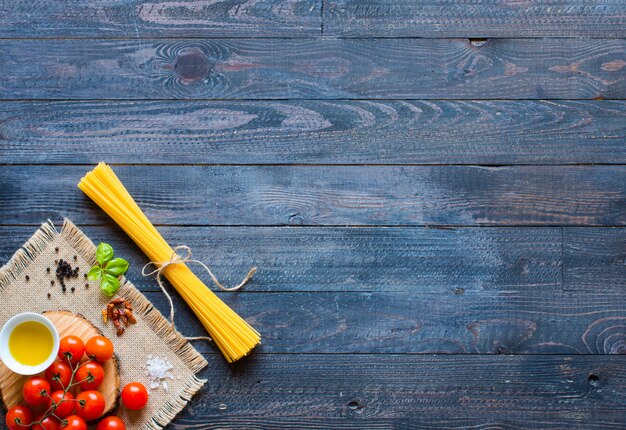 Different type of italian pasta on a wooden background