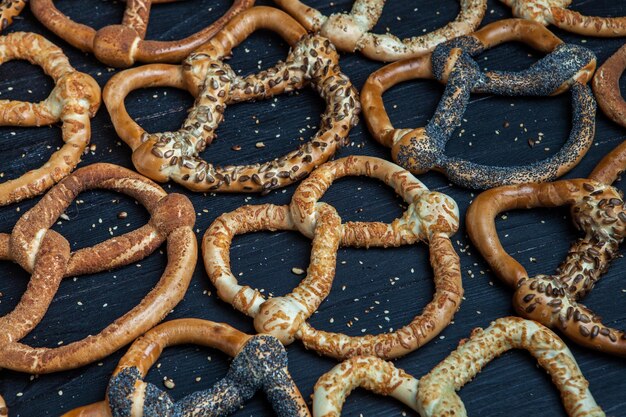 Different types of baked bagels with seeds