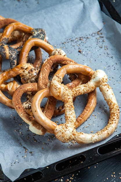 Different types of baked bagels with seeds