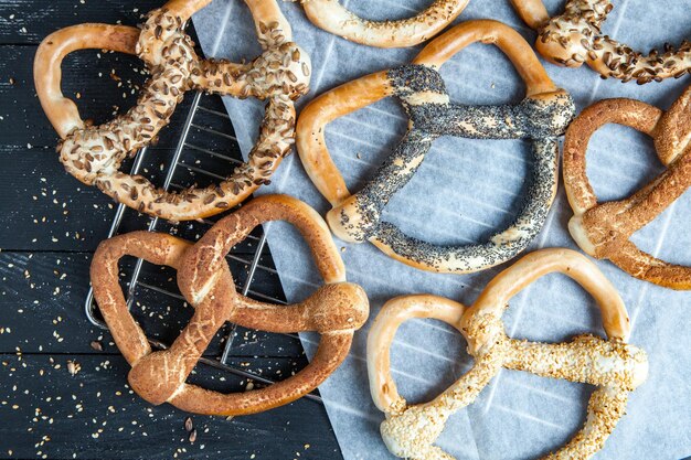 Different types of baked bagels with seeds