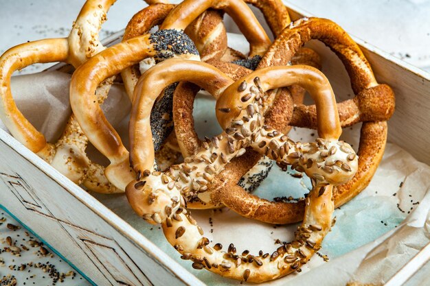 Different types of baked bagels with seeds