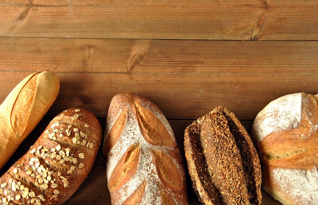 Different types of bread on a wooden table