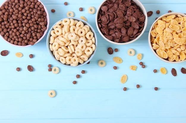 Different types of breakfast cereals on a light background closeup