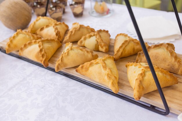 Different types of canapes on buffet table.