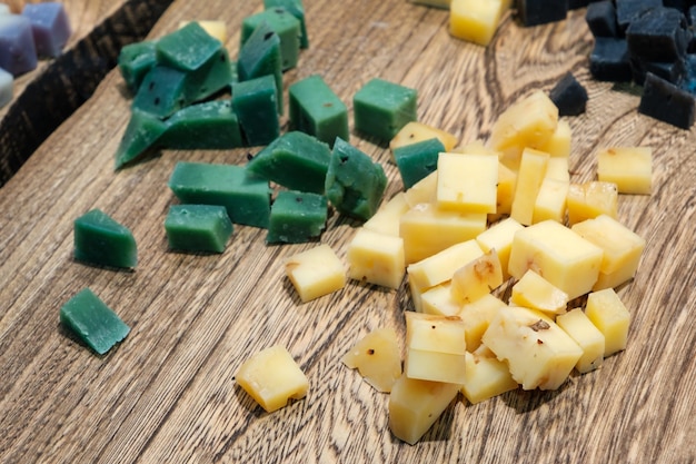 Different types of cheese on natural wooden table