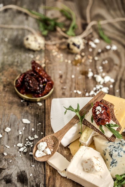 Different types of cheese with dates and quail eggs