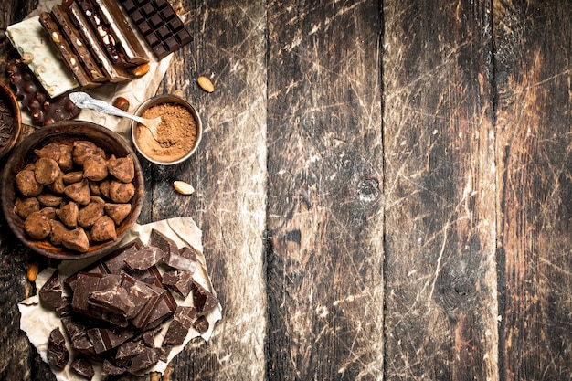 Different types of chocolate, cocoa powder and pieces of dark chocolate    