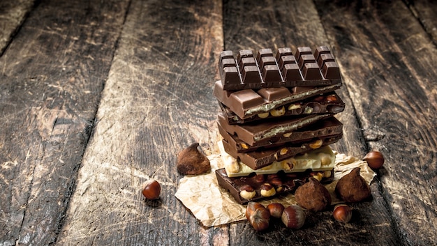 Different types of chocolate. On a wooden table.