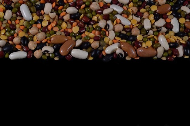 Photo different types of mixed legumes filling the image copy space on the right black background