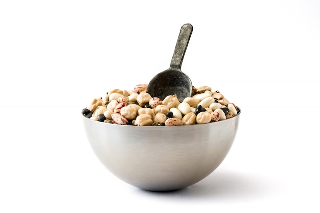 different types of mixed legumes in metal bowl isolated