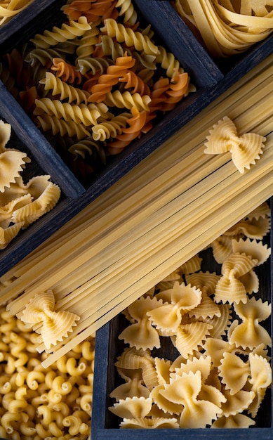 Different types of pasta in boxes, like a beautiful pasta wallpaper. High quality photo