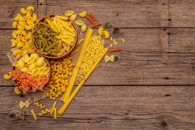 Different types of pasta in ceramic bowls