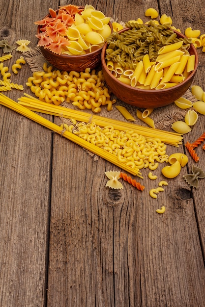 Different types of pasta in ceramic bowls