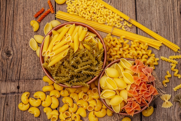 Different types of pasta in ceramic bowls