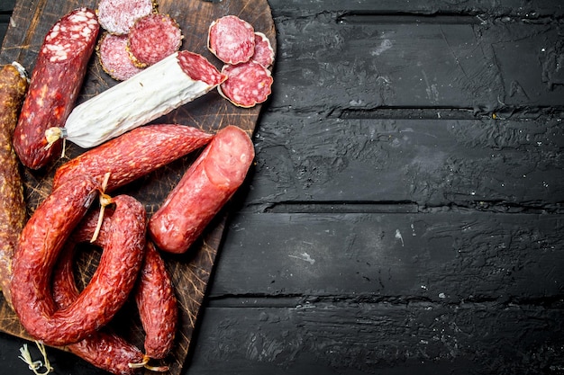 Different types of salami with spices and herbs