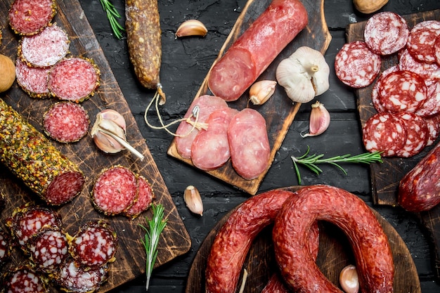 Different types of salami on wooden Board