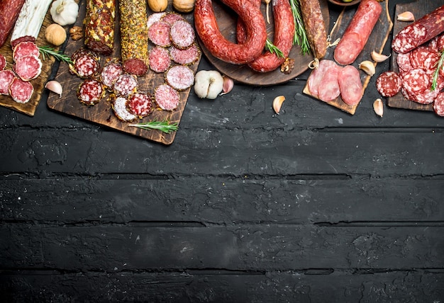 Different types of salami on wooden Board