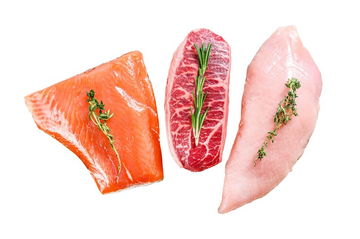 Photo different types of steaks on wooden table with herbs beef top blade salmon fillet and turkey breast organic fish poultry and beef meat isolated on white background top view