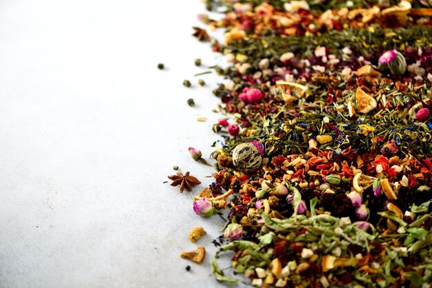 Different types of tea green black floral herbal mint melissa rose hibiscus cornflower Dry tea assortment with organic fruits berries ginger orange raspberry cranberry Top view