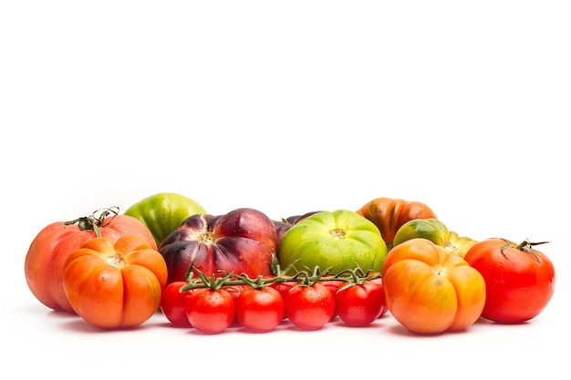 Different types of tomatoes isolated on a white background