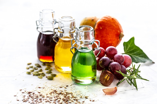 Different types of vegetable oil in glass bottles: sesame,\
linseed, grape oil.