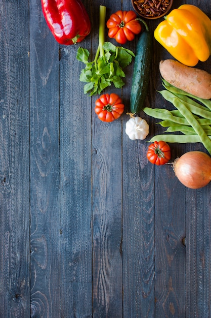 Different types of vegetables, on a old wooden table, background copyspace