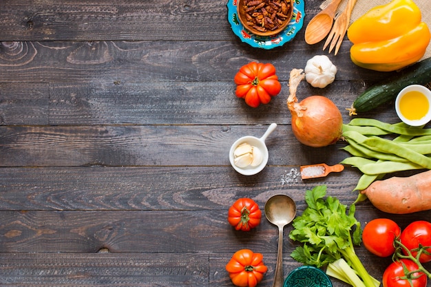 Different types of vegetables, on a old wooden table, background