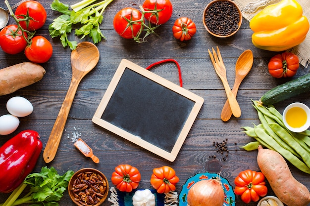 Different types of vegetables, on a old wooden table, space for text.