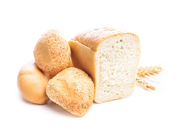 Different types of wheat bread and buns isolated on white