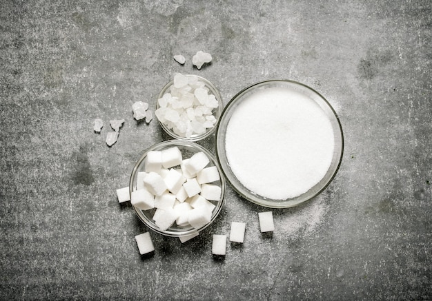 Different types of white sugar in a glass