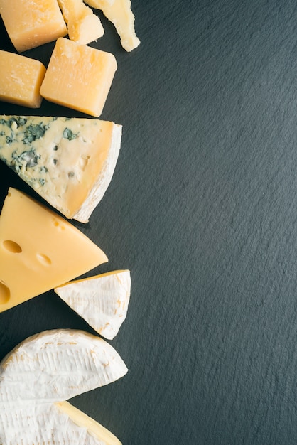 Different varieties of cheese on a black board