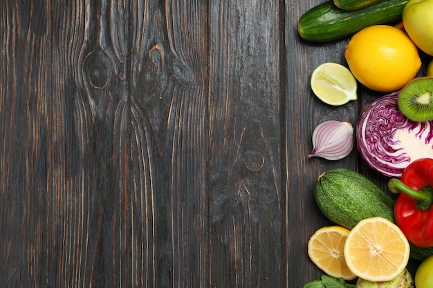 Different vegetables and fruits on wooden 