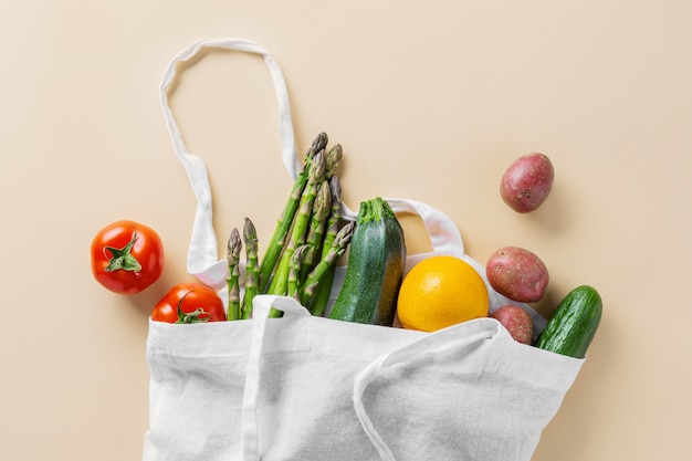 Different vegetables in textile bag on beige