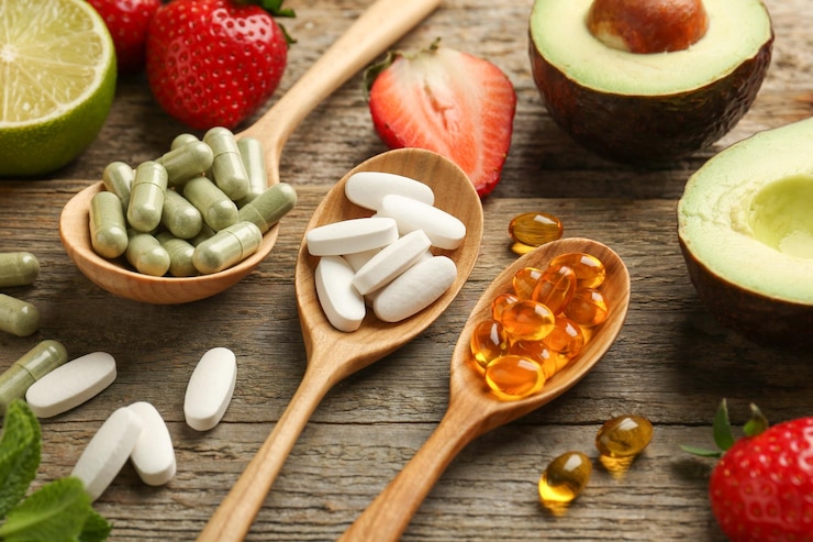 Photo different vitamin pills and fresh fruits on old wooden table