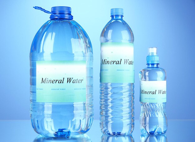 Different water bottles with label on blue background