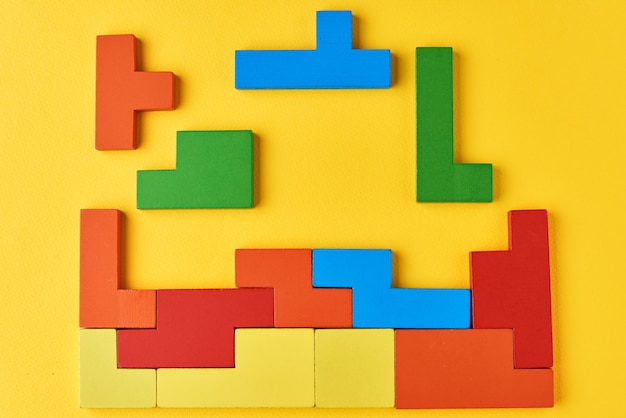 Different wooden blocks on a yellow background
